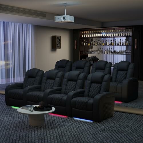Home theater with black recliner seats and a bar in the background.